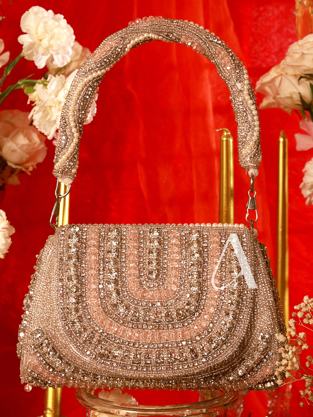 Decorative handbag with embellishments on a red background