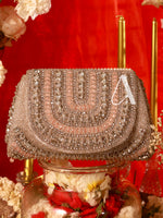 Decorative handbag with intricate beading on a red background