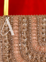 Close-up of a decorative item with intricate patterns and a letter 'A' on a red background
