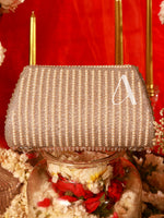 Decorative lamp with a textured shade and floral base against a red background