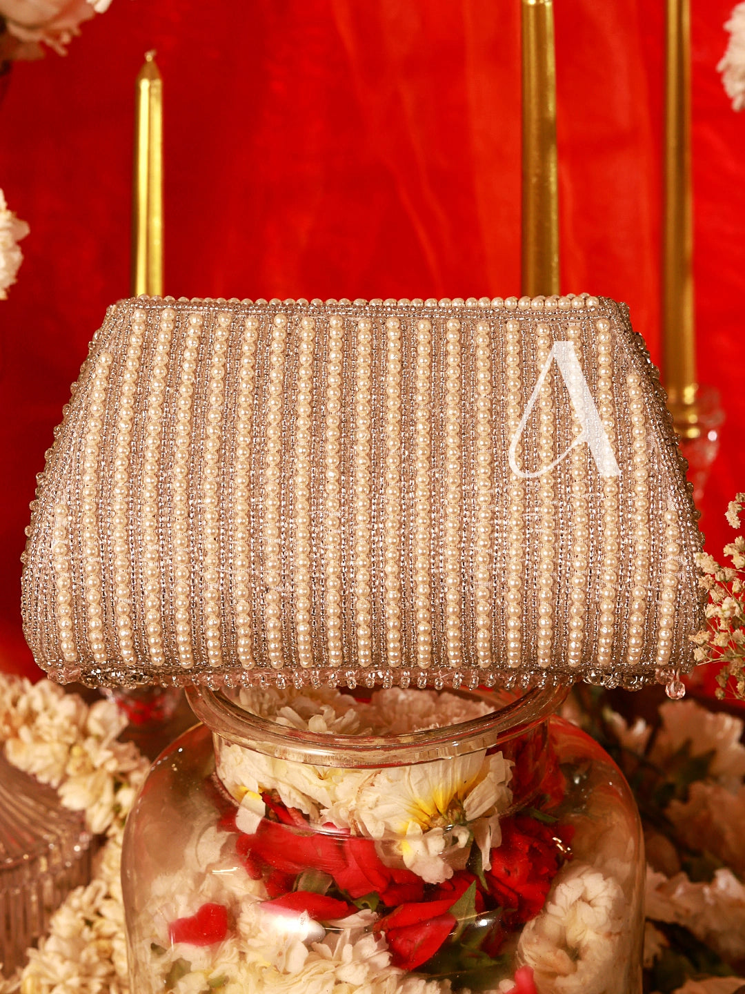 Decorative lamp with a textured shade and floral base against a red background