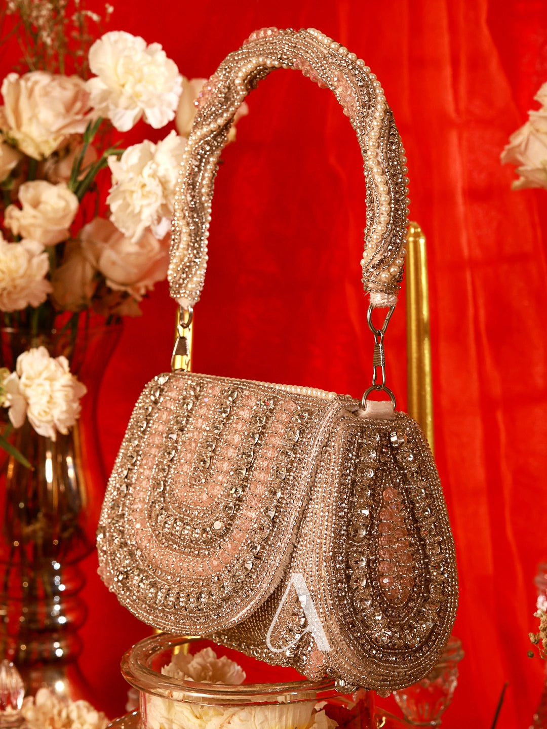 Decorative handbag with intricate designs on a red background