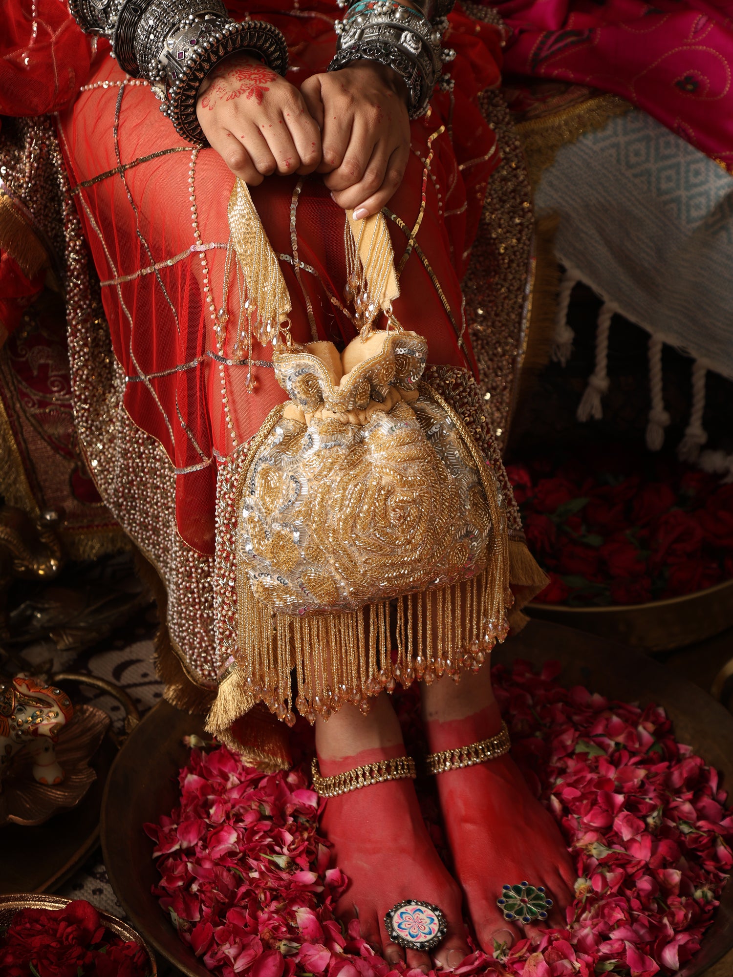 Traditional outfit with a gold and red handbag on a decorative background
